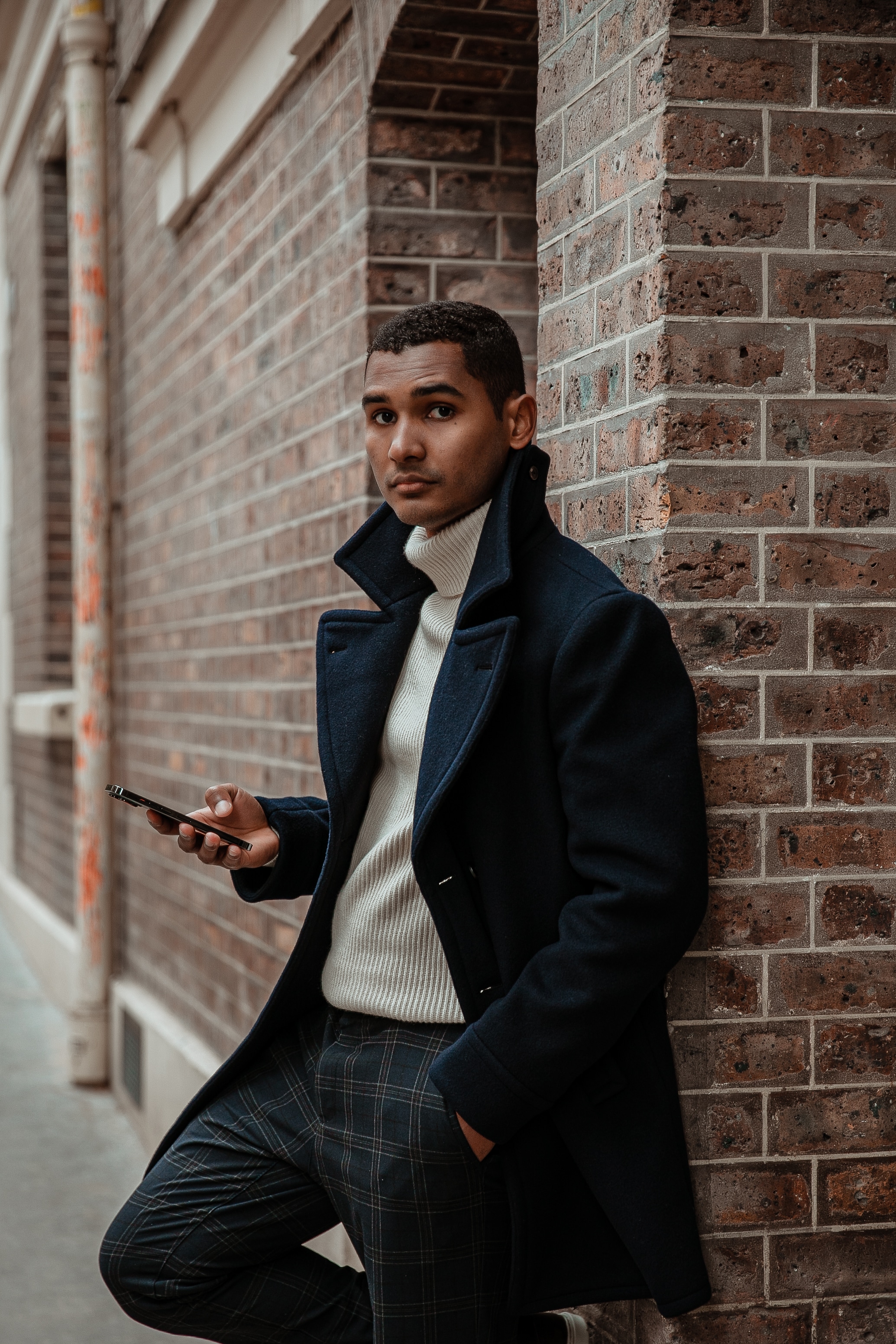Gabriel Welzel standing beside a brick wall