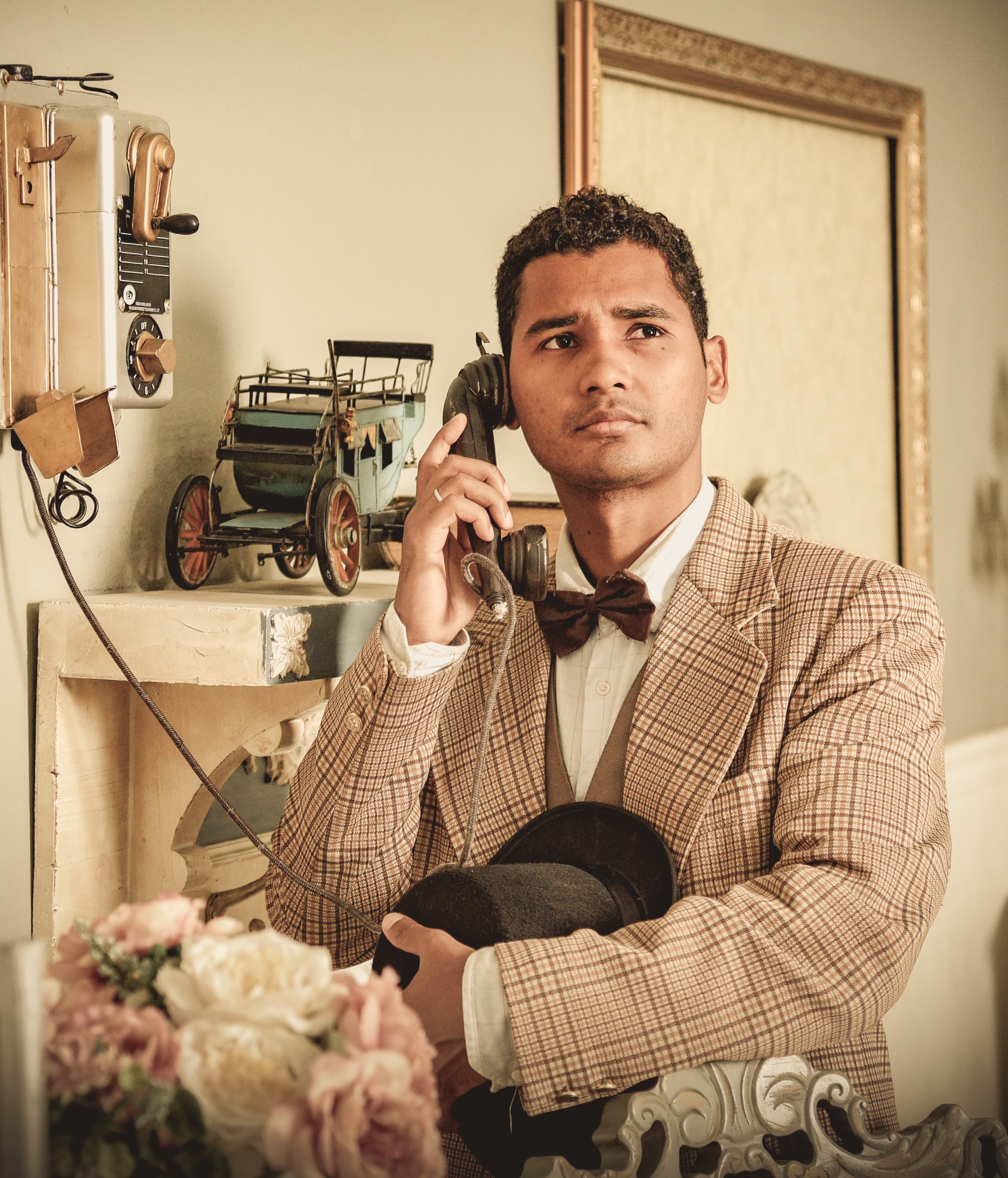 Gabriel Welzel speaking on a vintage telephone